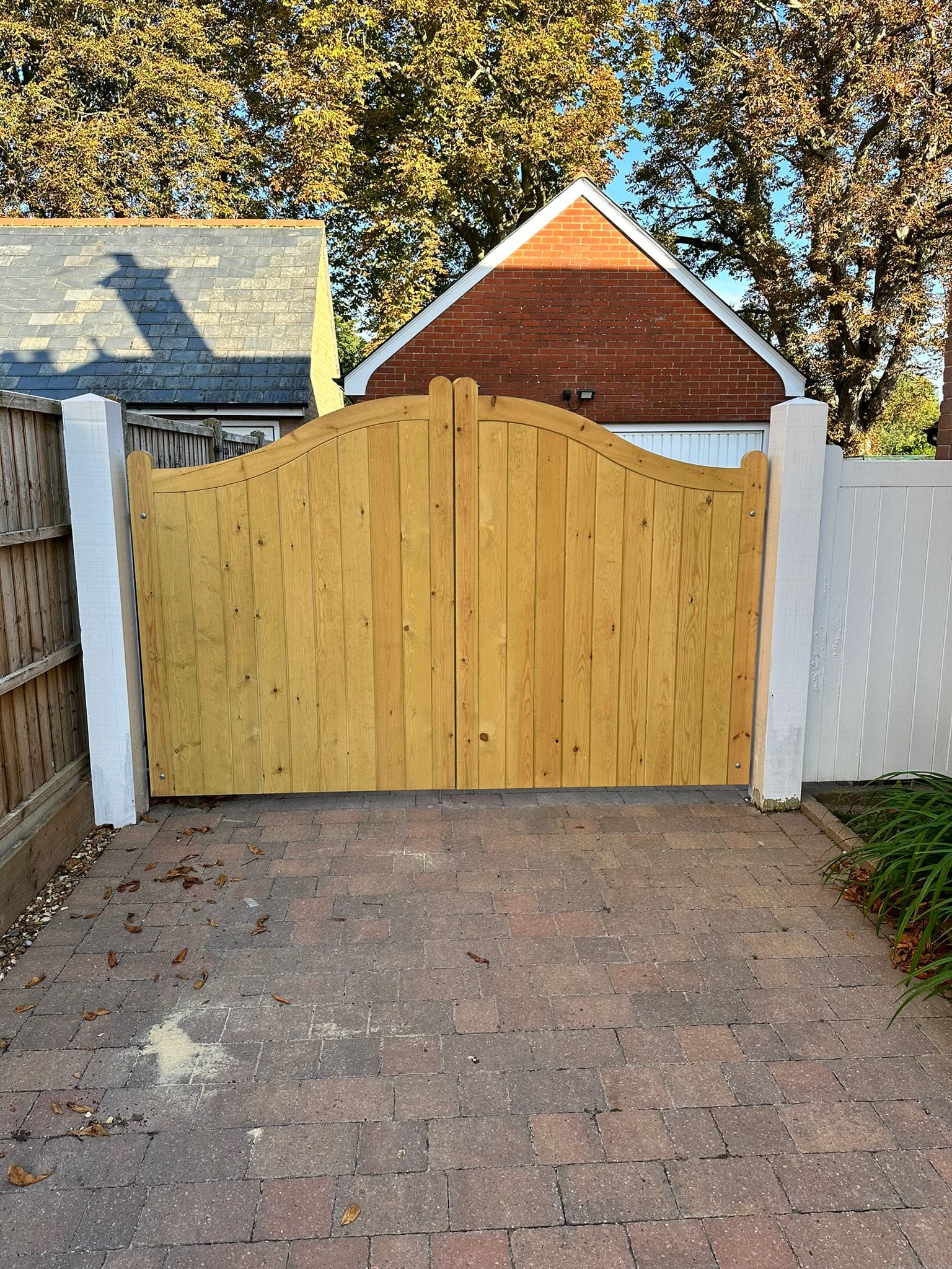 An image showing a new brown double wooden garden gate.