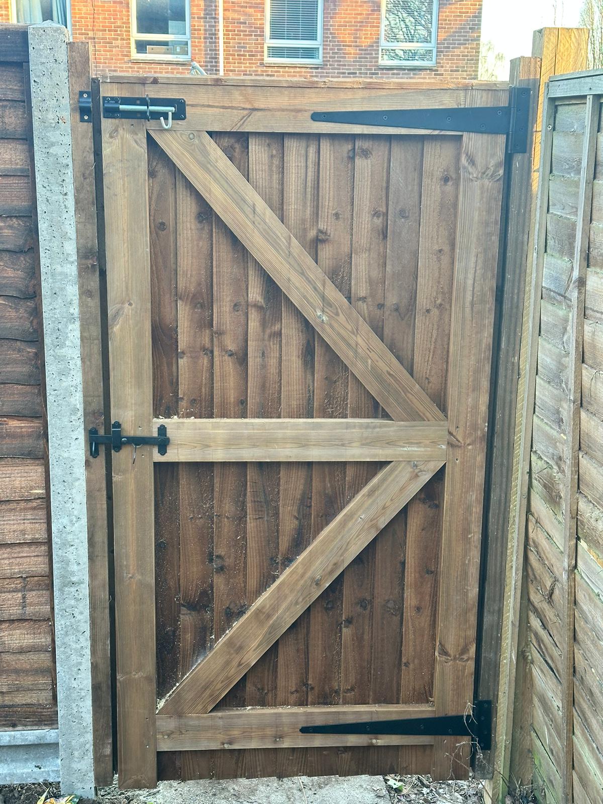 An image showing a new brown wooden garden gate.