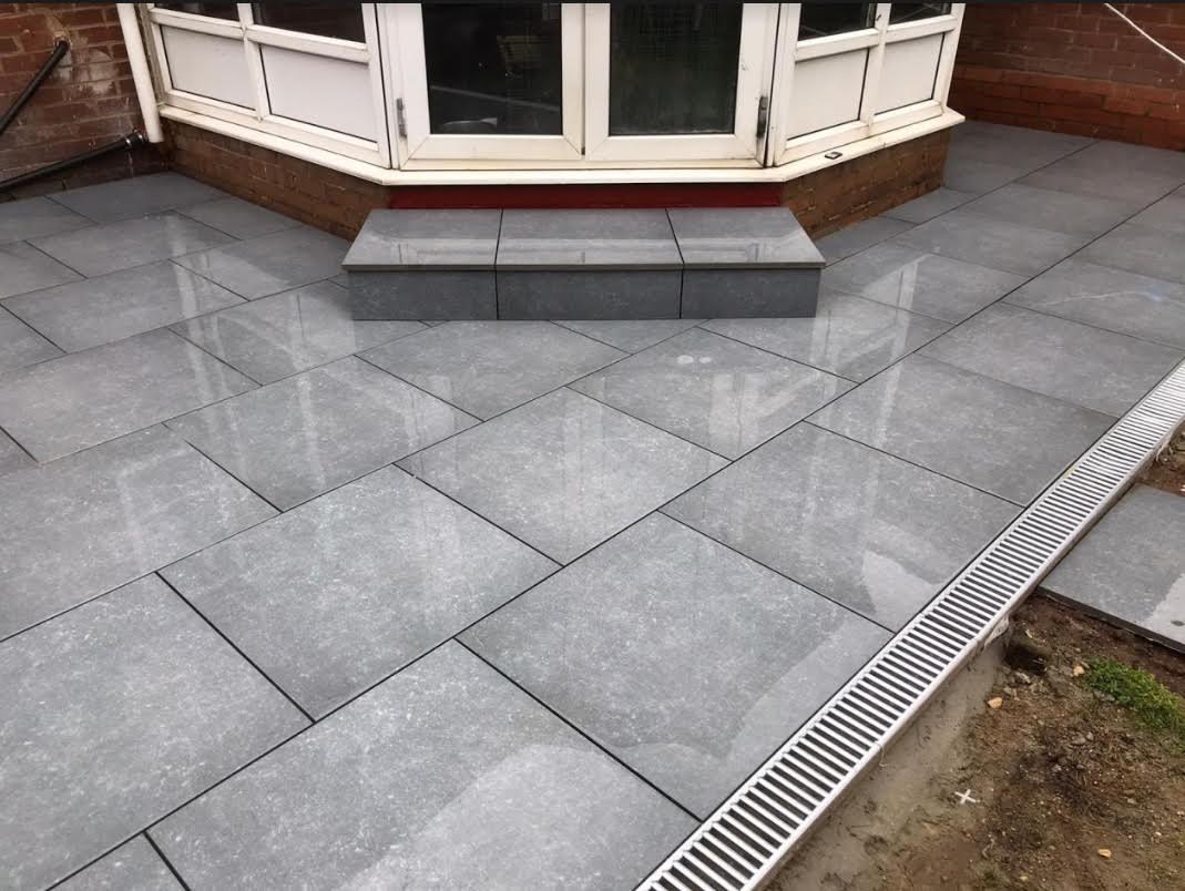 Dark grey patio with steps.